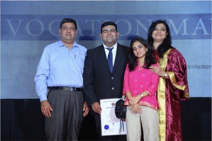 Tejas on stage holding his ICAI certificate, flanked by his father, his sister and his mother in convocation robes