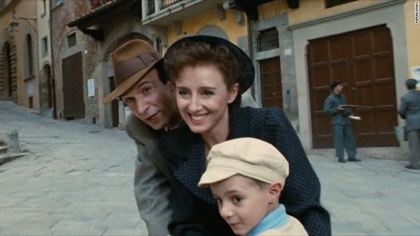 A still from Life Is Beautiful: Guido, Dora and their small son on a street
